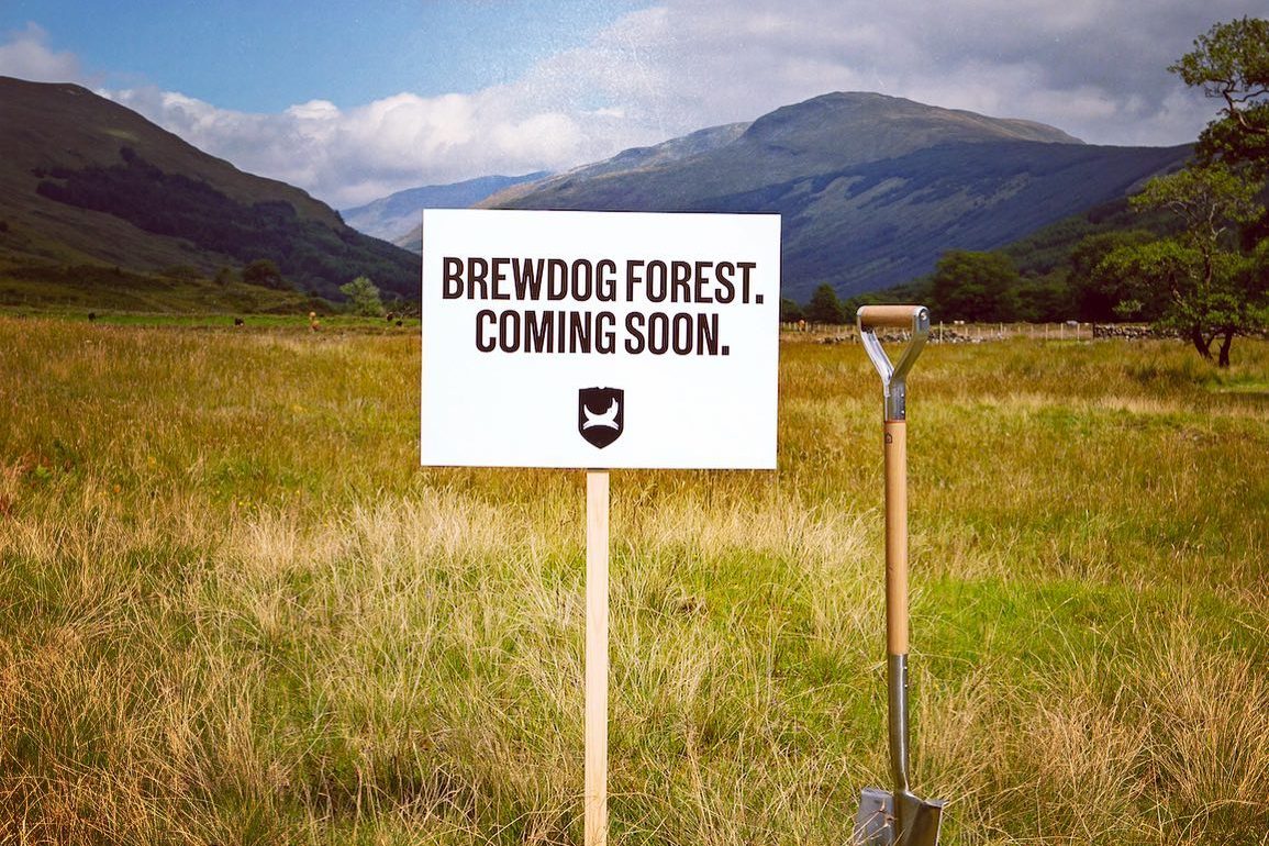 BrewDog Forest coming soon sign with shovel in field.