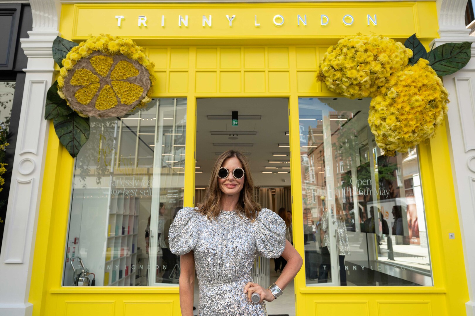Trinny Woodall at the opening of her London pop-up store, decorated with floral lemon designs.
